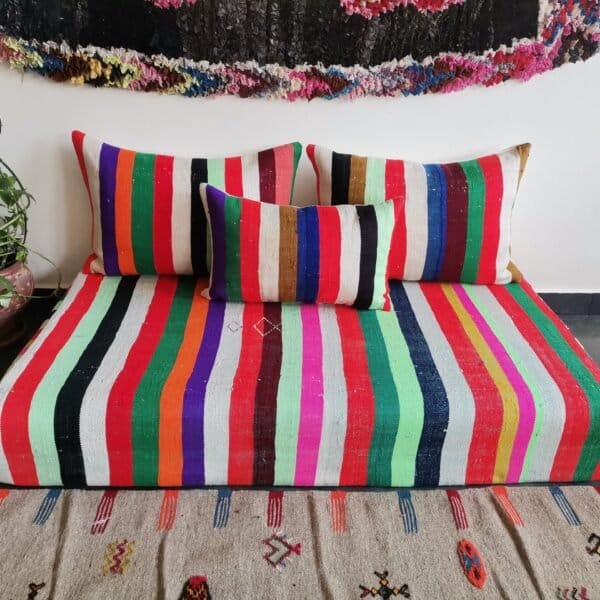 Top-down view of Moroccan wool couch in multiple vibrant stripes – handmade low seating for lively interiors