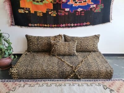 Top view of Moroccan floor sofa with black and mustard tones – artisan seating for strong, stylish interiors