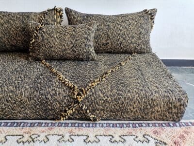 Close-up of mixed black and mustard cushions – handwoven Moroccan covers for cozy and stylish floor setups
