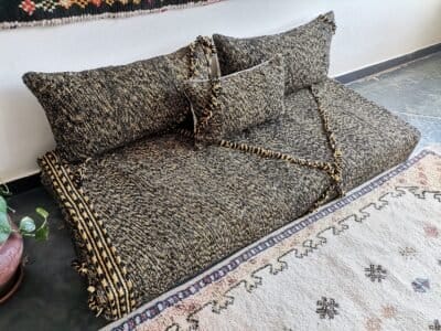 Top view of Moroccan floor sofa with black and mustard tones – artisan seating for strong, stylish interiors