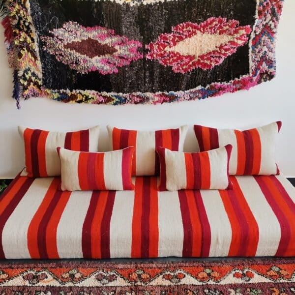 Top view of artisan Moroccan wool sofa in cream with red and orange stripes – handmade floor seating for bohemian and minimalist spaces