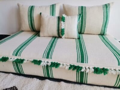 Cushions from Moroccan sofa in cream with green stripes and pom-pom detail – artisan wool pillows for joyful boho decor