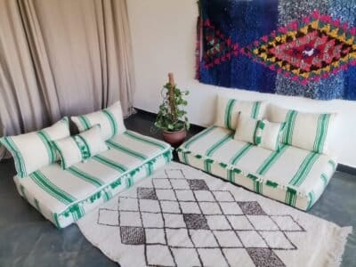 Moroccan wool sofa with green stripes and pom-poms – unique low couch for artistic interiors