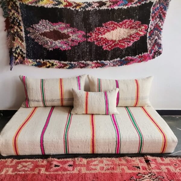 colorful Moroccan wool sofa in cream with multi-stripe pattern – artisan floor couch with boho cushions