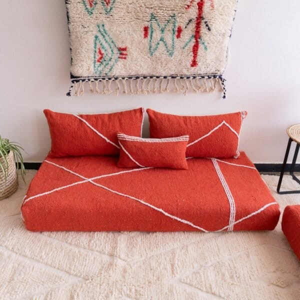 Handwoven orange Moroccan floor couch with minimalist cushions – ideal for boho-chic or eclectic living room decor
