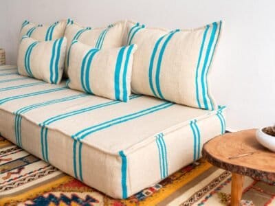 Right view of handmade Moroccan wool floor sofa in cream and turquoise – perfect for relaxed boho-chic homes