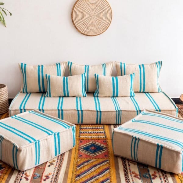 Main image of Moroccan floor sofa in cream with turquoise stripes – artisan handwoven wool couch for boho and coastal-style interiors