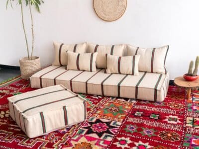 Right view of Moroccan floor sofa in cream with red and green – handmade wool couch for cozy living spaces
