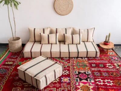 Main image of Moroccan wool floor couch in cream with red and green stripes – low handcrafted seating with cushions for festive boho vibes
