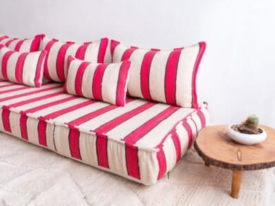 Moroccan artisan wool sofa with cream base and red/black stripes – handmade for low boho floor living