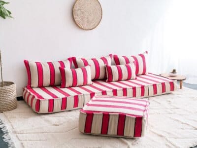 Left view of handmade Moroccan floor sofa in cream with bold red and black lines – traditional wool seating with a modern touch