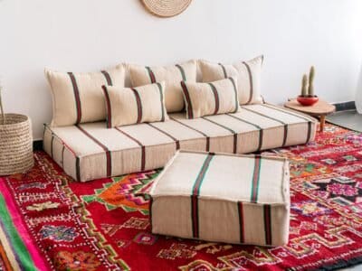 Left side of artisan wool floor sofa in festive red and green stripes – Moroccan handmade low seating