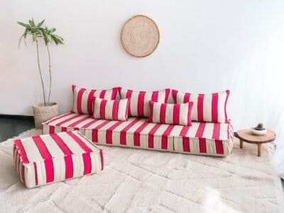 Right side of Moroccan wool floor sofa with artisan red and black striped pattern – cozy low seating for modern bohemian interiors