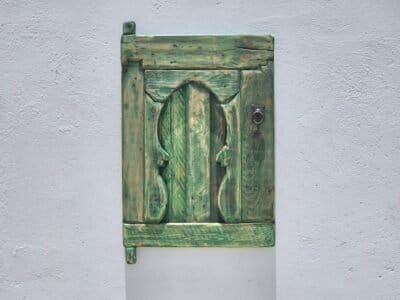 traditional Amazigh carvings on weathered cedar wood wall panel