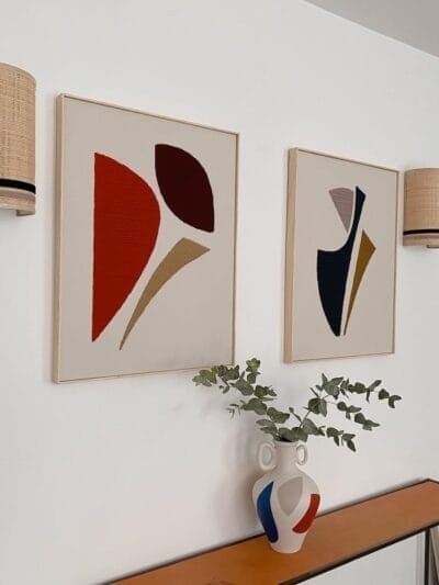 Framed abstract wool wall art hanging on a neutral-colored wall, adding warmth and texture to a modern living room.