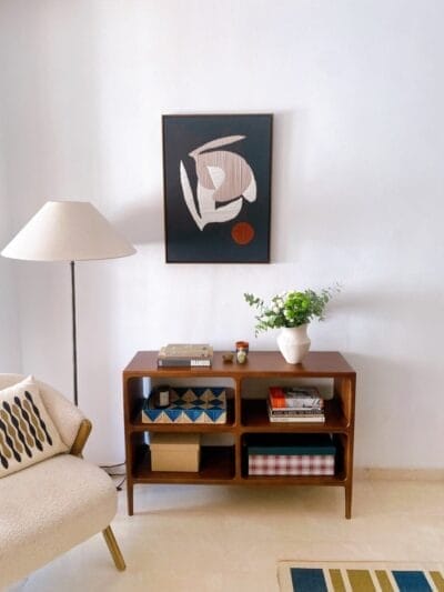 Framed abstract wool artwork hanging on a wall in a modern interior setting, showcasing minimalist organic design.