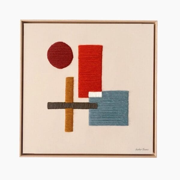 Framed Kanica wool wall art hanging on a neutral wall, adding warmth and texture to a modern boho living room
