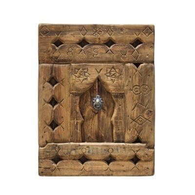 Handcrafted vintage Moroccan wall panel featuring tribal Berber carvings and rustic aged wood