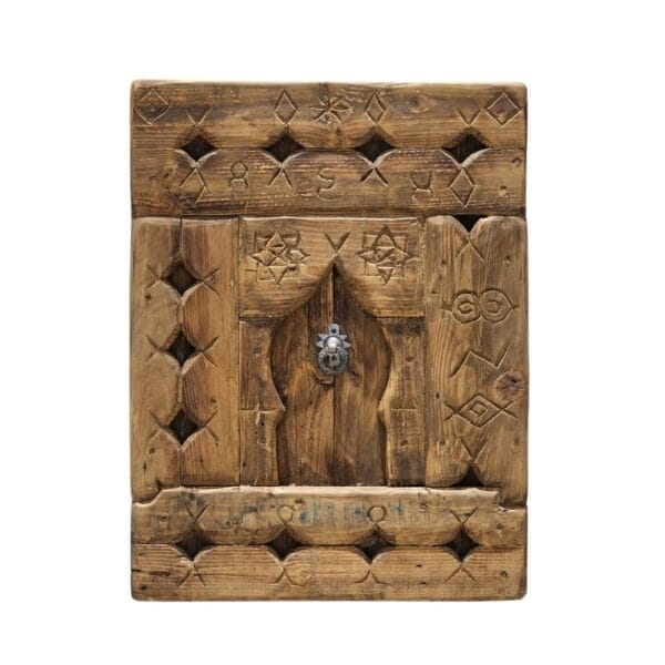 Handcrafted vintage Moroccan wall panel featuring tribal Berber carvings and rustic aged wood