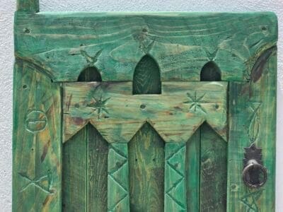 Vintage Moroccan handcrafted window panel styled as rustic wall decor in interior space