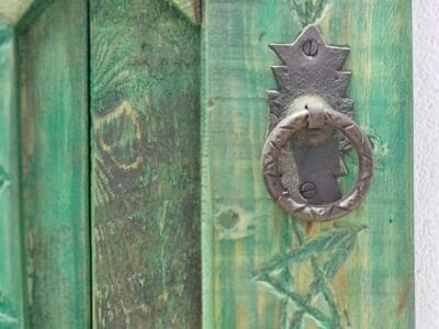carved details and iron studwork on the vintage Moroccan wooden window