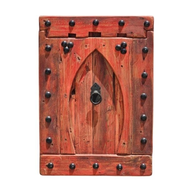 Vintage Moroccan wall panel with Moorish arch design in red rustic wood, mounted on white wall