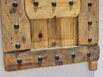 Bottom panel view of the rustic Moroccan shutter with visible wood grain and iron rivets