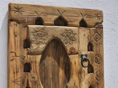 Intricate Berber-Inspired Carvings and Rustic Finish on Amazigh Wooden Panel