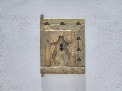 Berber carvings on aged cedar wood panel