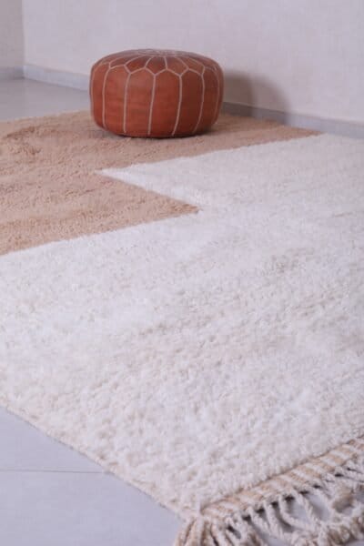 fringe on Moroccan ivory and tan rug, showcasing the hand-knotted finish and soft wool fiber quality.