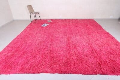 Right side of rose pink Moroccan rug made from 100% natural wool.