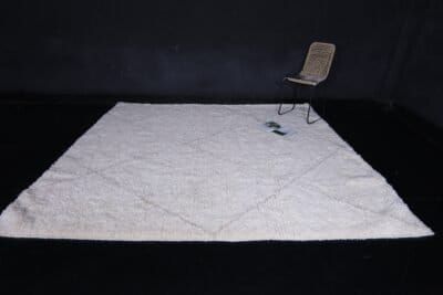 Moroccan wool rug in white with tan trellis design, illustrating quality weaving and thick, plush pile.