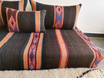 embroidered stripes on black and orange wool cushion fabric