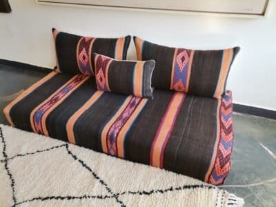 Unfilled Moroccan floor cushions with zippered covers laid out flat