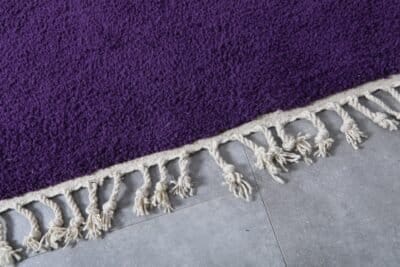 Fringe detail of handmade Moroccan royal purple wool rug.