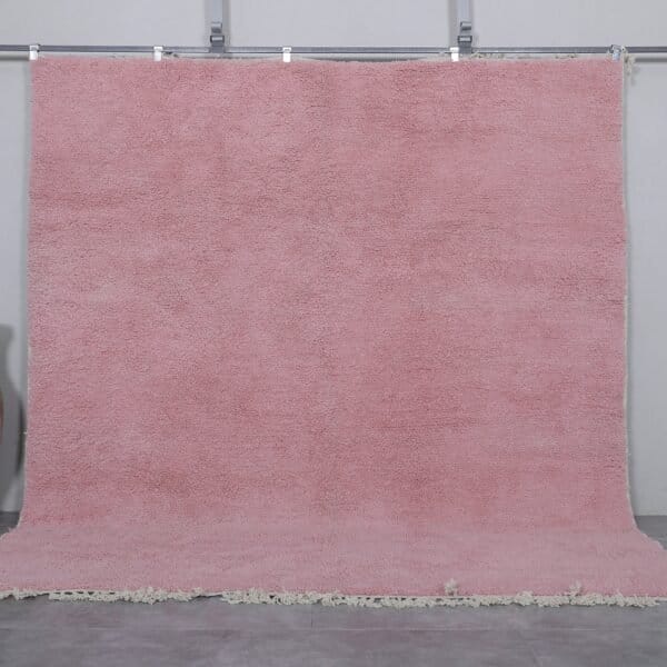 Authentic handmade Moroccan millennial pink rug, crafted from 100% natural wool using traditional Beni Ourain weaving. This soft and elegant solid pink area rug is perfect for modern interiors, bedrooms, or boho living rooms.