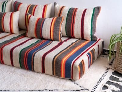 Stacked Moroccan cushion covers showing colorful striped embroidery