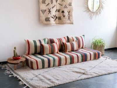 Boho living room with ivory lamb wool Moroccan floor sofa set featuring multicolor stripes