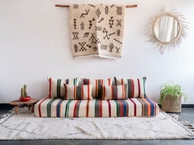 Handmade Moroccan wool floor sofa set with ivory lamb wool base and vibrant multicolor striped embroidery, unstuffed cushion covers with hidden zippers