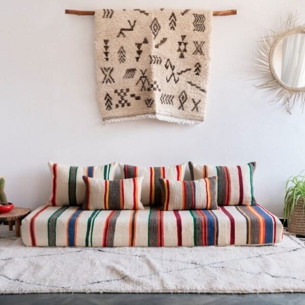 Handmade Moroccan wool floor sofa set with ivory lamb wool base and vibrant multicolor striped embroidery, unstuffed cushion covers with hidden zippers
