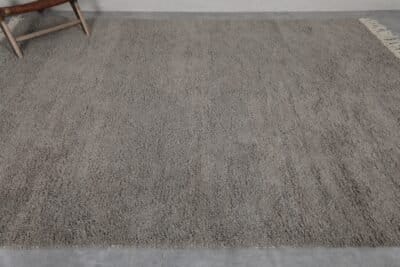 Top-down view of taupe Moroccan Beni Ourain rug with solid wool surface.