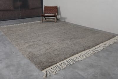 Fringe detail of handmade taupe Moroccan rug crafted by Berber artisans.