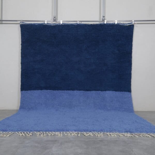 Handmade Moroccan Beni Ourain rug in a light and cobalt blue blend, crafted from 100% natural lamb wool by Berber artisans in the Atlas Mountains.