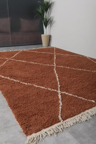 Moroccan rug in terracotta and ivory, illustrating its thickness, quality wool material, and handcrafted precision.