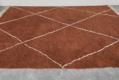 handmade terracotta Moroccan rug with ivory pattern, crafted from genuine lamb wool using traditional Berber techniques.