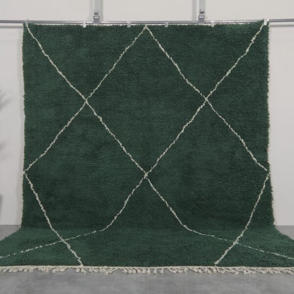 Handmade Moroccan rug in solid dark green, woven from 100% natural lamb wool by Berber artisans, featuring an optional trellis-style Beni Ourain pattern for a rich, earthy interior accent.