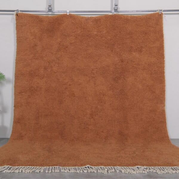 Authentic handmade Moroccan rug in warm rust color, crafted with soft natural wool and traditional Berber Beni Ourain patterns.