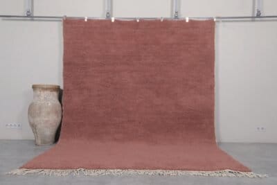Handmade Moroccan rust brown Beni Ourain rug crafted with 100% natural lamb wool, featuring a rich, earthy solid color and a plush shag texture, perfect for adding warmth and elegance to modern or rustic interiors.