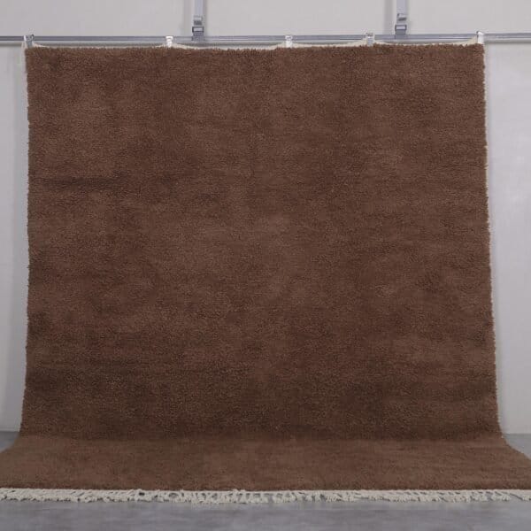 Authentic handmade Moroccan Beni Ourain rug in solid brown, woven from 100% lamb’s wool by Berber artisans. A timeless wool area rug for earthy, modern, or rustic interiors.