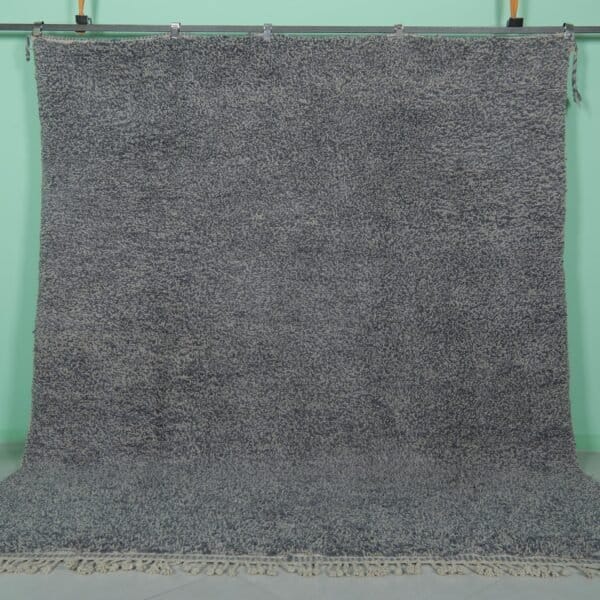 Handmade Moroccan gray wool rug with traditional Beni Ourain tribal patterns, crafted by skilled Berber artisans from 100% natural lamb wool, featuring a soft, durable pile perfect for living rooms and bedrooms with modern or rustic decor